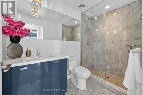 Second bathroom with walk-in shower and navy vanity